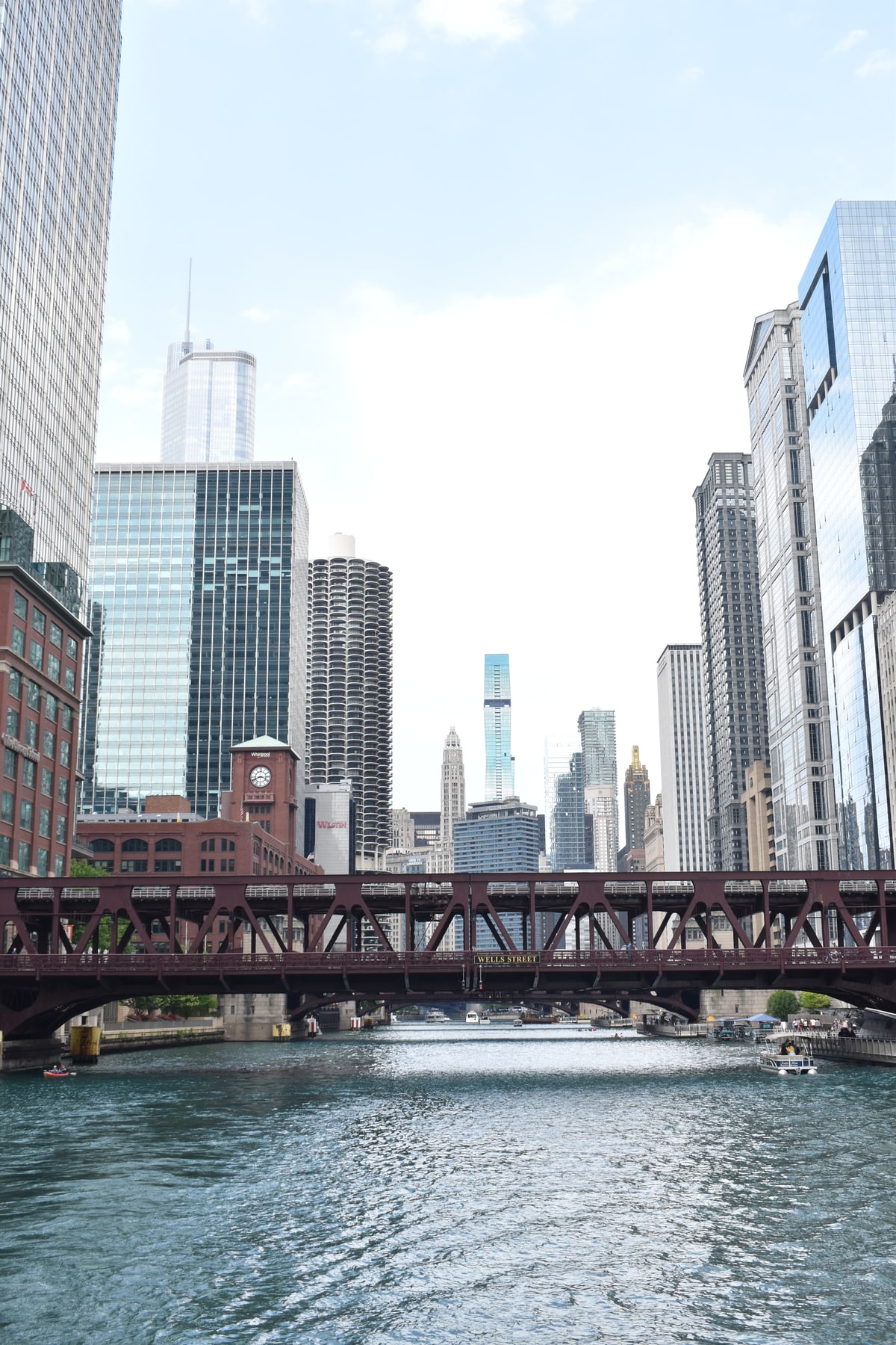 Bridges stack along the Chicago River between tall buildings.