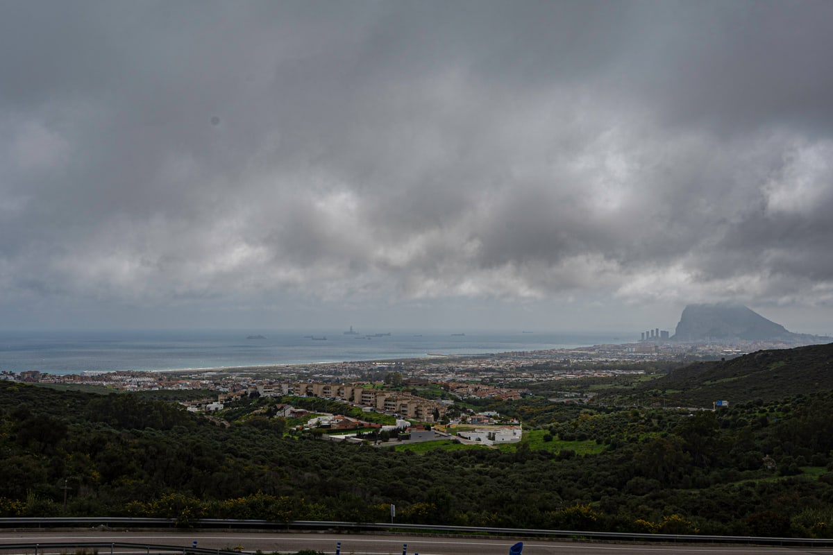Storm clouds over the coast with the Rock of Gibraltar in the distance.